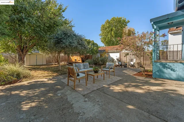 a view of a house with backyard and sitting area