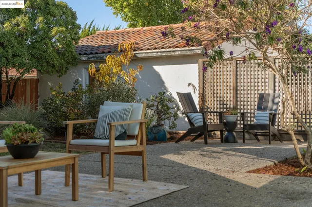 a view of a backyard with sitting area