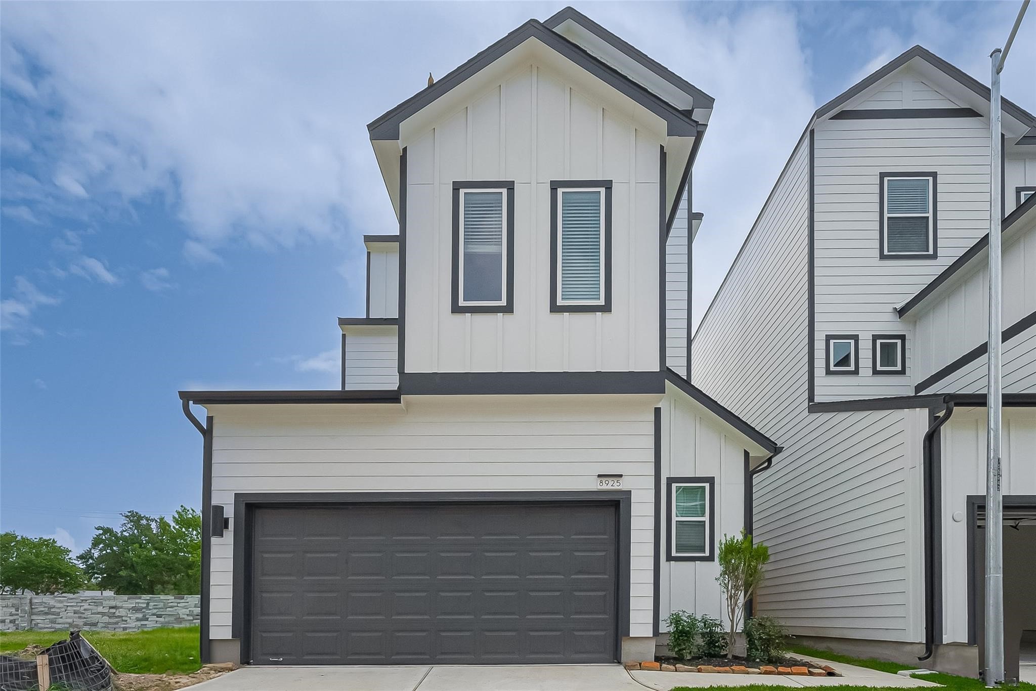 a front view of a house with garage