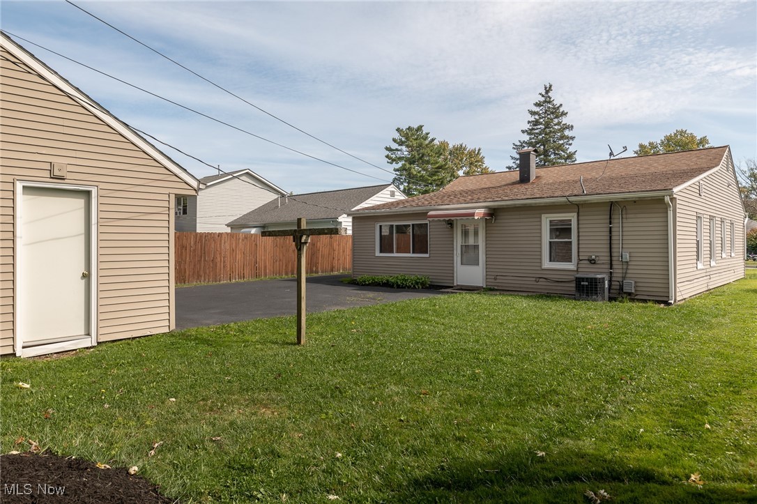 4782 Belle Meadow Road Mentor, OH 44060 - Photo 5 of 22 Back of house featuring a shed, a lawn, a patio, and central air condition unit