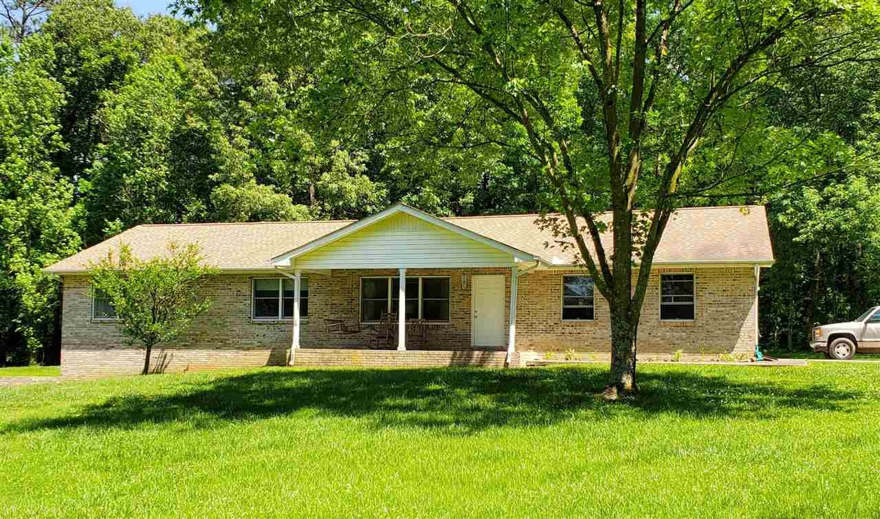 1627 Strawhill Road Southeast Cleveland, TN 37323 - Photo 1 of 48 a front view of a house with a garden and yard