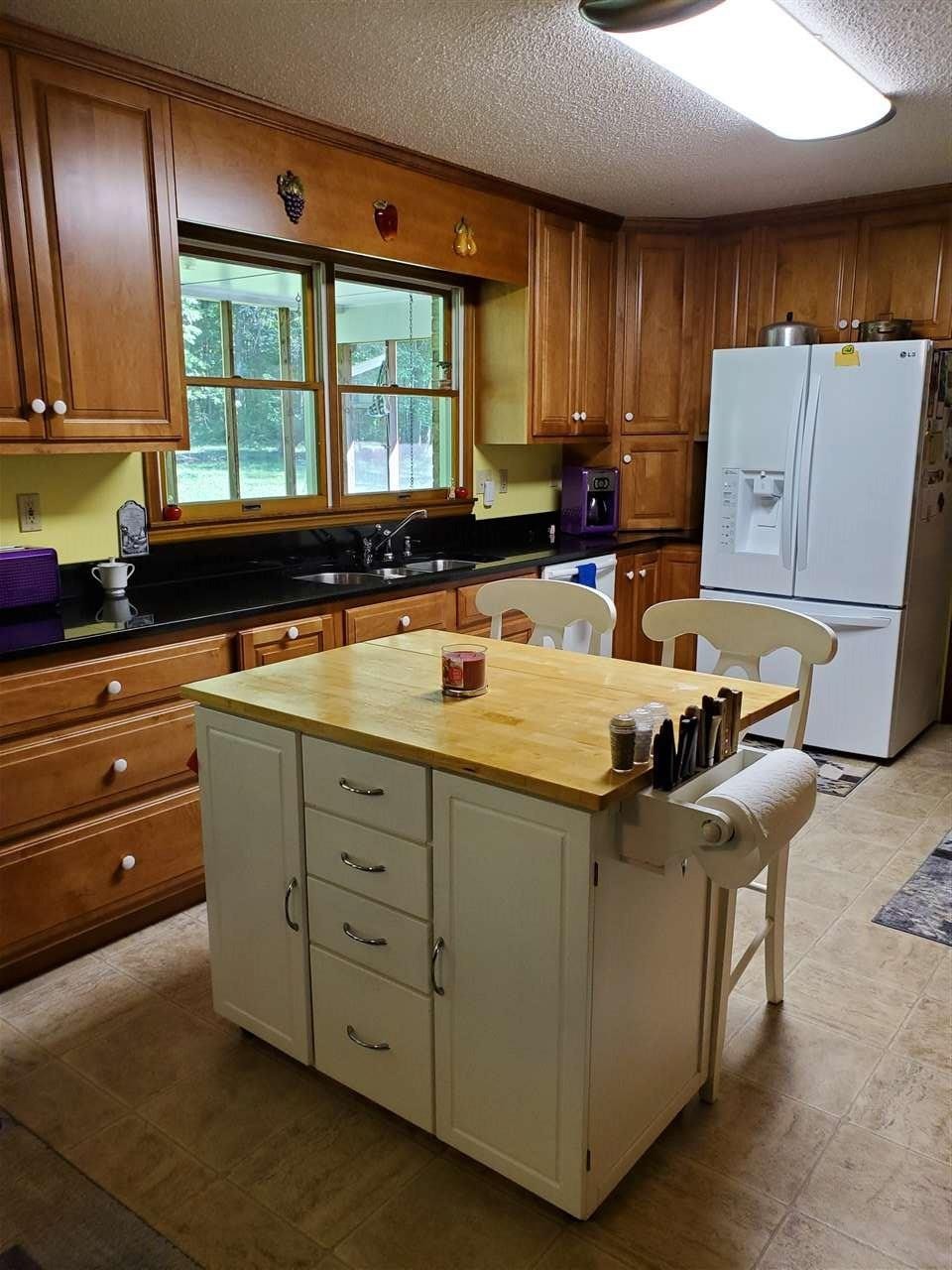 1627 Strawhill Road Southeast Cleveland, TN 37323 - Photo 13 of 48 a kitchen with a stove a refrigerator and a sink