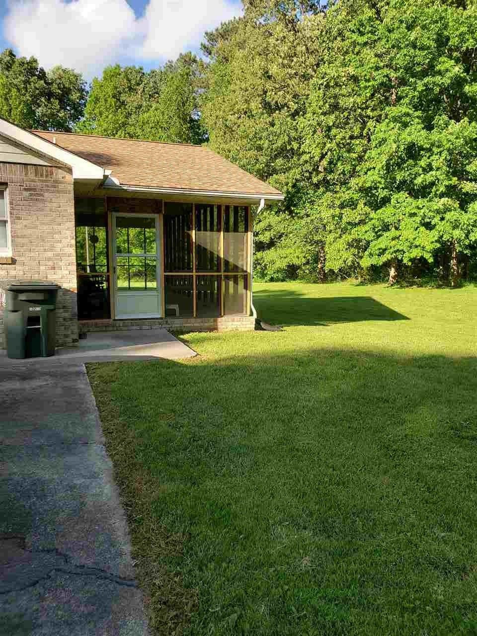 1627 Strawhill Road Southeast Cleveland, TN 37323 - Photo 3 of 48 a front view of a house with a yard table and chairs