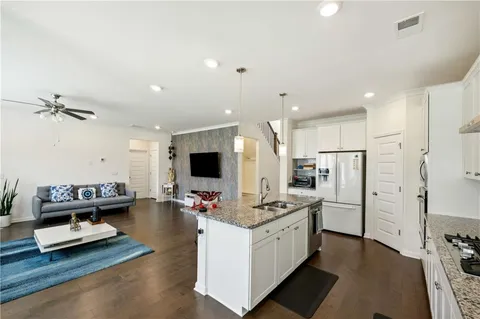 a kitchen with refrigerator and cabinets