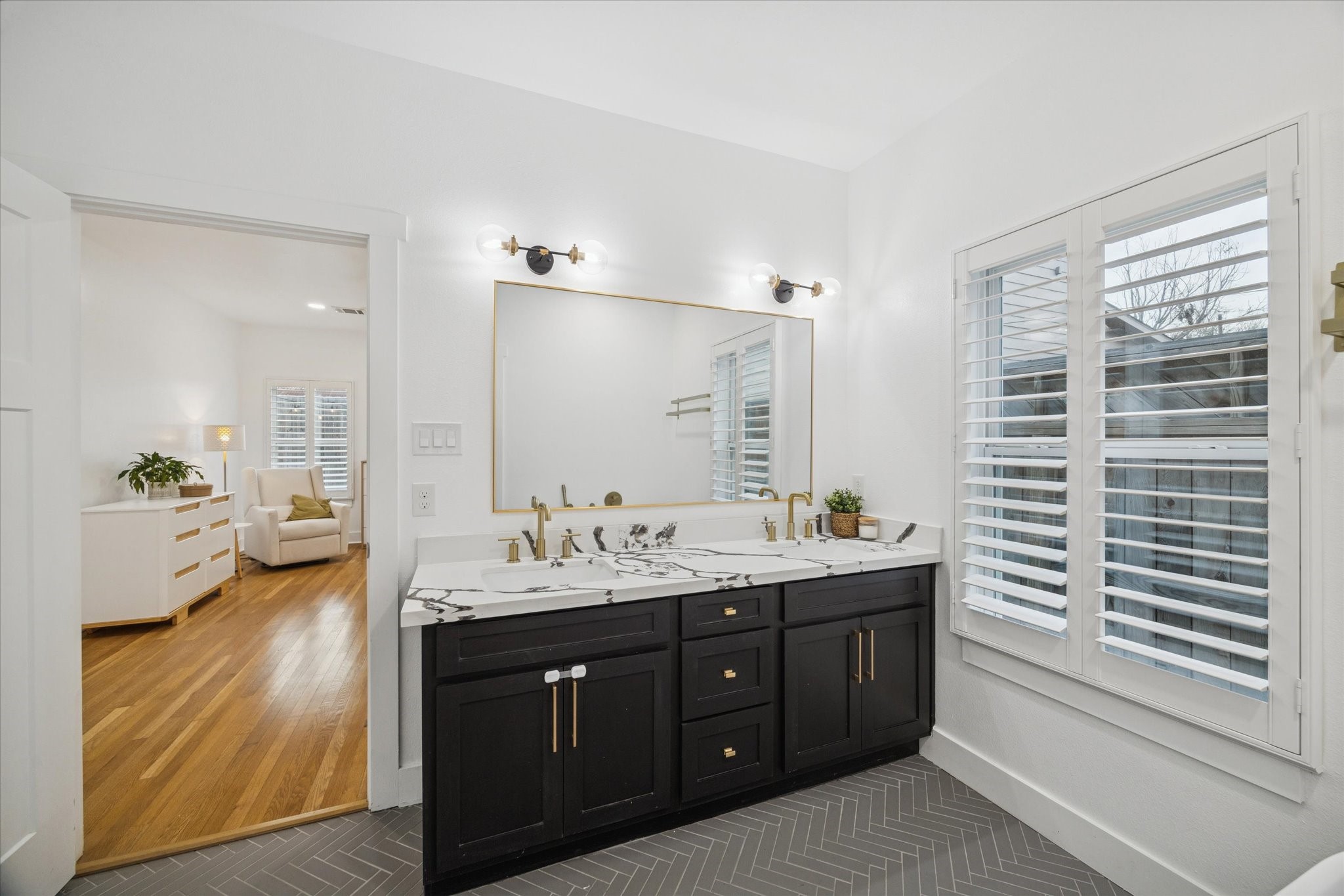 207 Tabor Street Houston, TX 77009 - Photo 14 of 25 a en suite bathroom with a double vanity sink a large mirror and shower