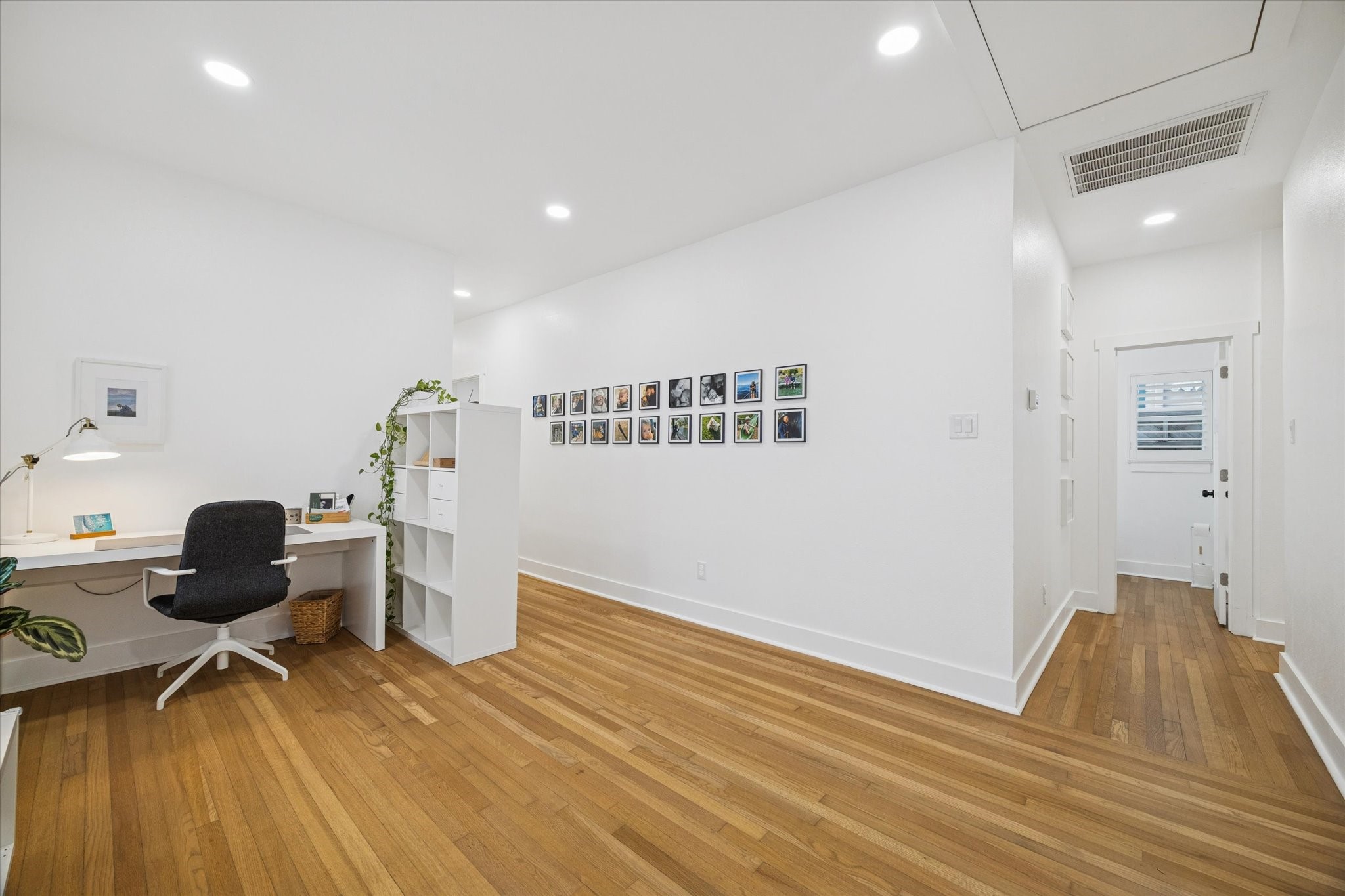 207 Tabor Street Houston, TX 77009 - Photo 9 of 25 a workspace with wooden floor and furniture