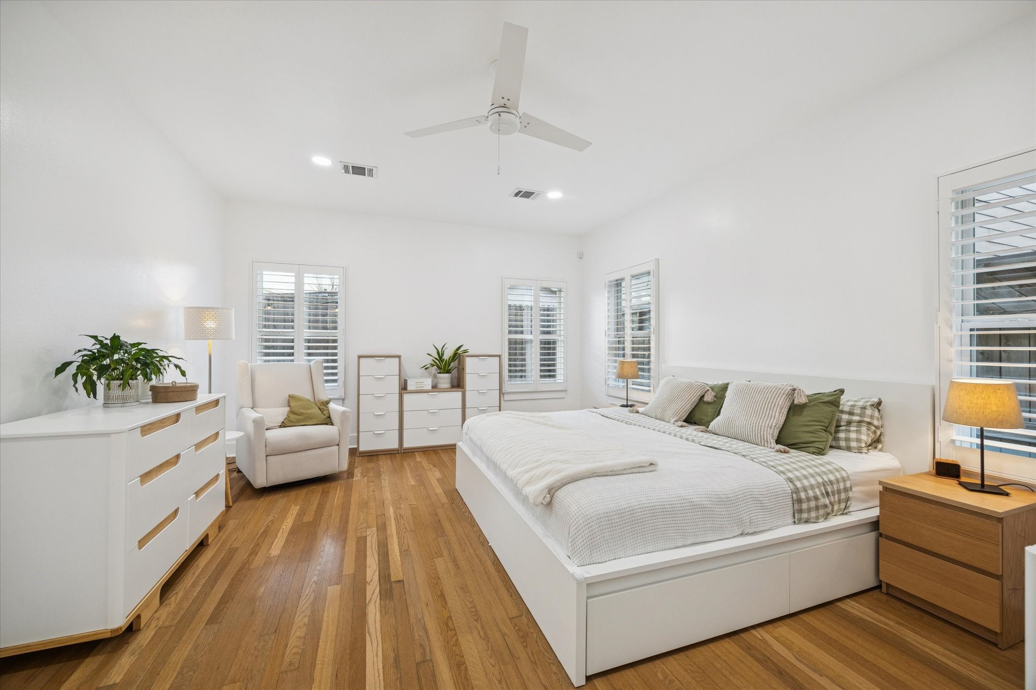 207 Tabor Street Houston, TX 77009 - Photo 10 of 25 a spacious bedroom with a large bed and a couch