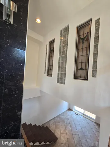 a view of an entryway with a bench