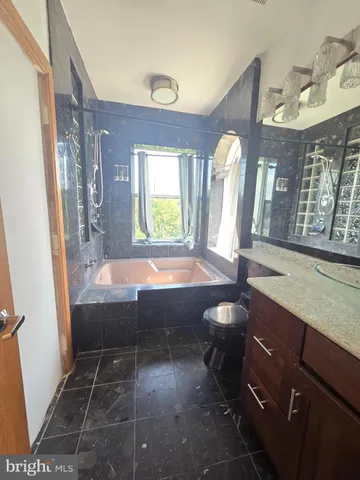 a bathroom with a sink a bathtub and a shower