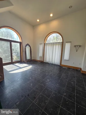 a view of empty room with a fireplace