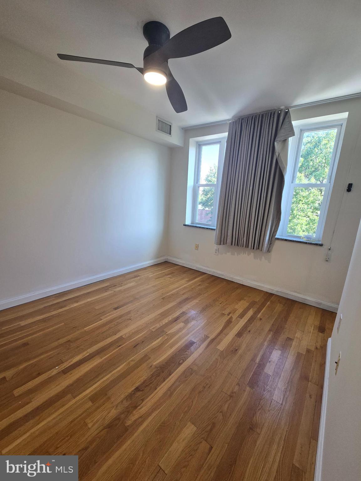 793 South Front Street Philadelphia, PA 19147 - Photo 8 of 32 a view of an empty room with wooden floor and a window