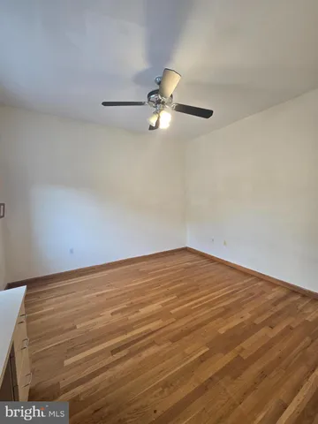 a view of empty room with ceiling fan