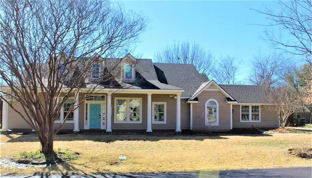 a front view of a house with a yard covered with snow
