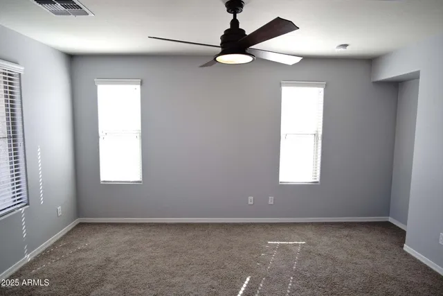 a view of a livingroom with a ceiling fan and window