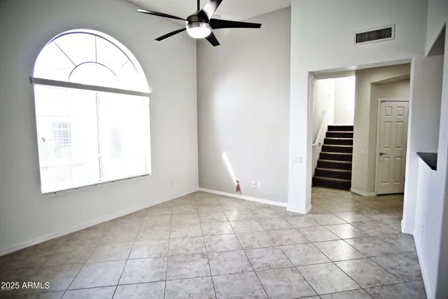 an empty room with a bathroom and a window