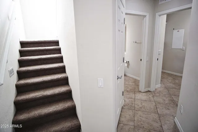 a view of staircase with white walls