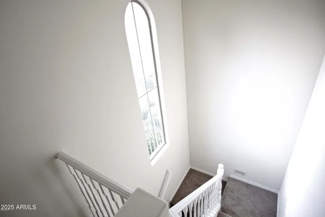 a view of a hallway with wooden floor and closet