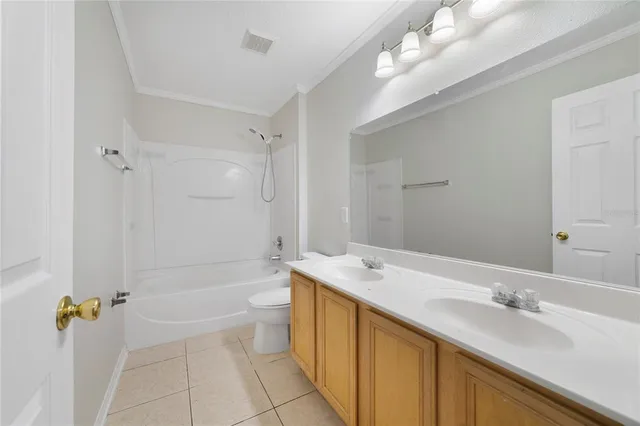 a bathroom with a granite countertop sink a toilet and shower