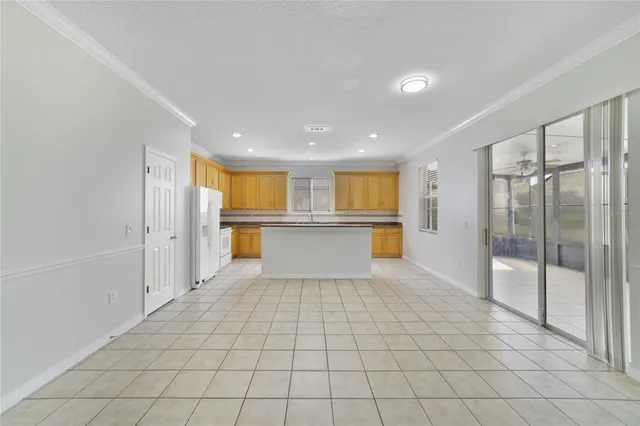 a view of a kitchen with a refrigerator and a sink