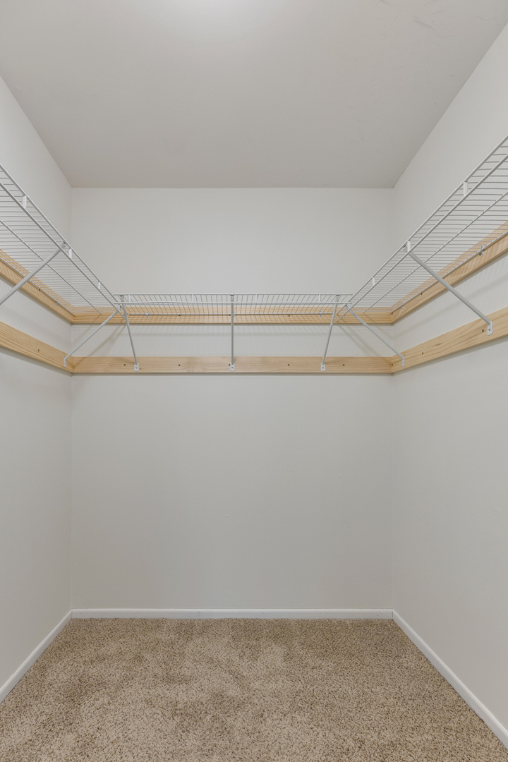 96 Gant Circle, Unit B Streamwood, IL 60107 - Photo 12 of 21 a view of a room with racks on the wall