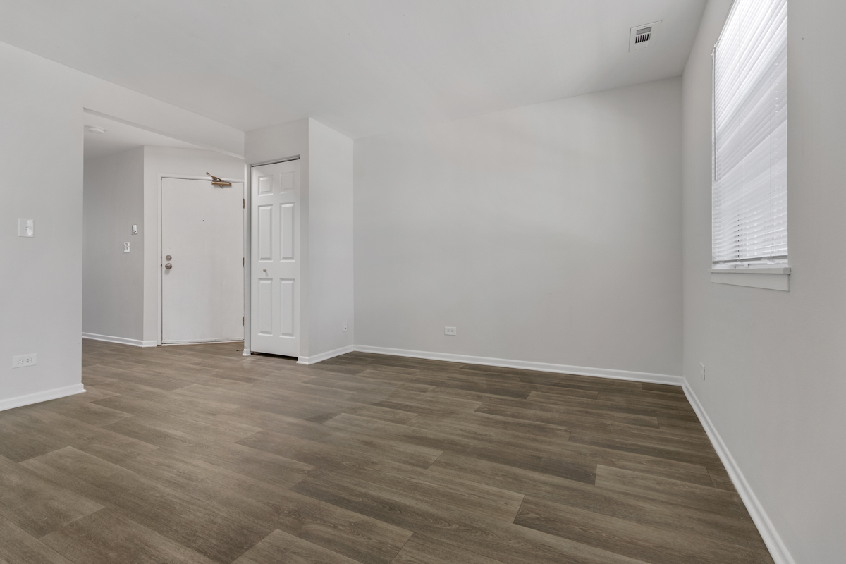 96 Gant Circle, Unit B Streamwood, IL 60107 - Photo 15 of 21 a view of an empty room with wooden floor and a window