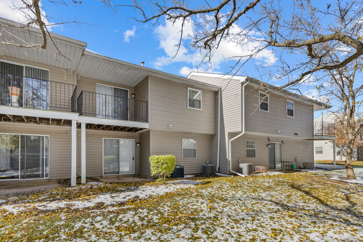 96 Gant Circle, Unit B Streamwood, IL 60107 - Photo 19 of 21 a front view of a house with a yard