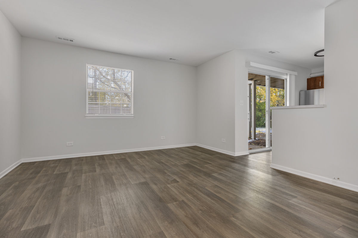 96 Gant Circle, Unit B Streamwood, IL 60107 - Photo 2 of 21 a view of an empty room with wooden floor and a window