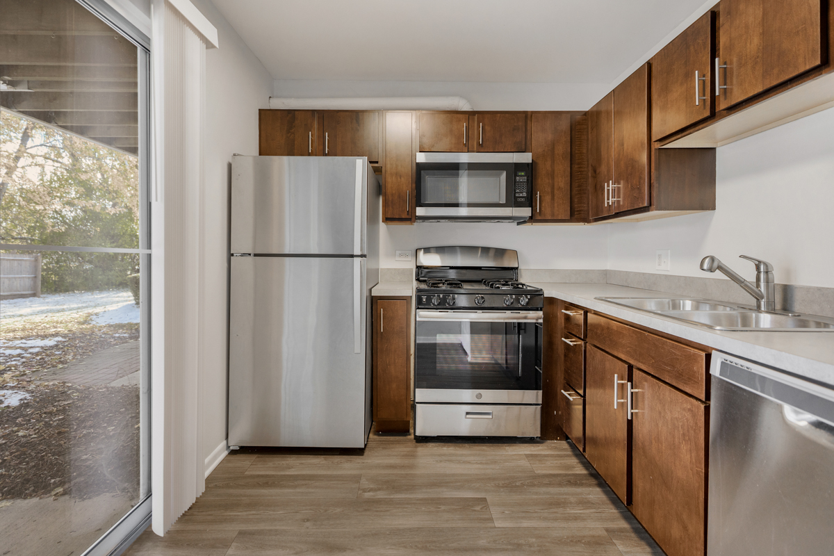 96 Gant Circle, Unit B Streamwood, IL 60107 - Photo 4 of 21 a kitchen with a refrigerator stove and sink