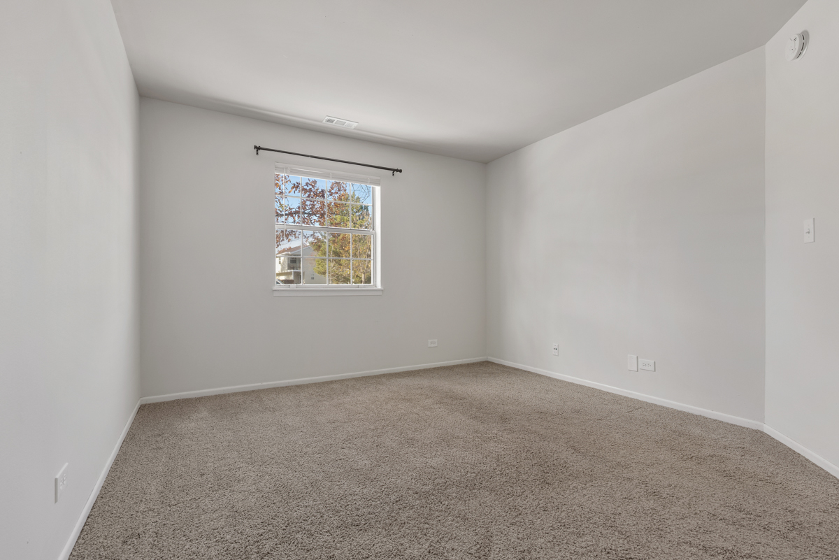 96 Gant Circle, Unit B Streamwood, IL 60107 - Photo 10 of 21 an empty room with windows