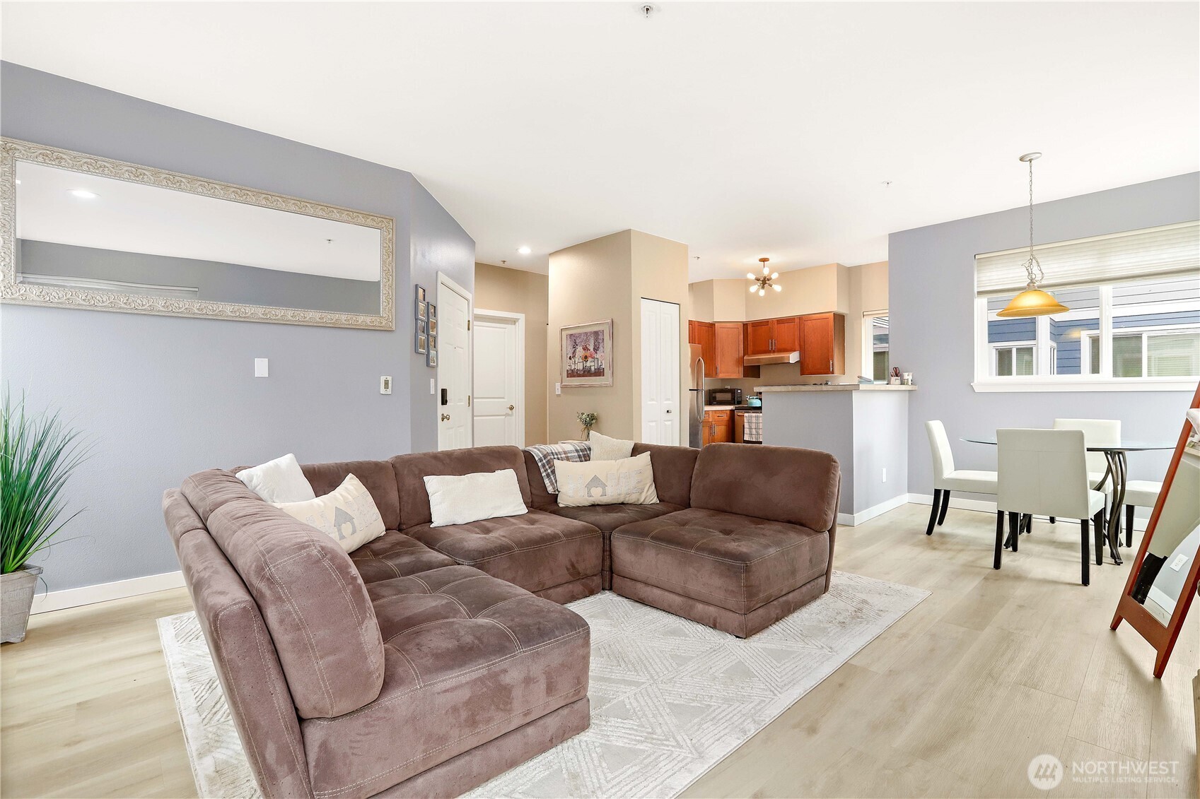3906 243rd Place Southeast, Unit P202 Bothell, WA 98021 - Photo 5 of 17 a living room with furniture kitchen view and a large window
