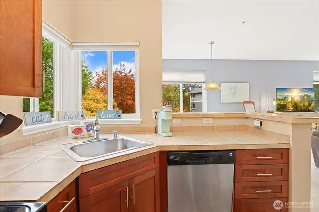 a kitchen with a sink stove and cabinets