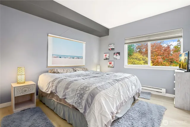 a bedroom with a bed and a large window