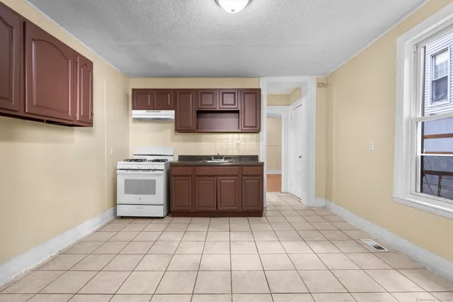 a kitchen with stainless steel appliances a stove a sink and a refrigerator