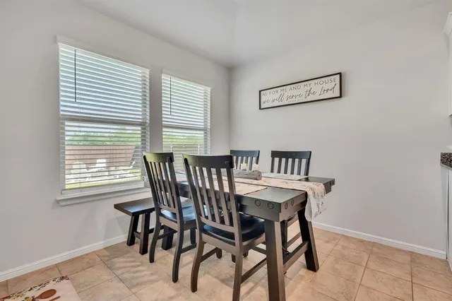 a view of a dining room with furniture and a window