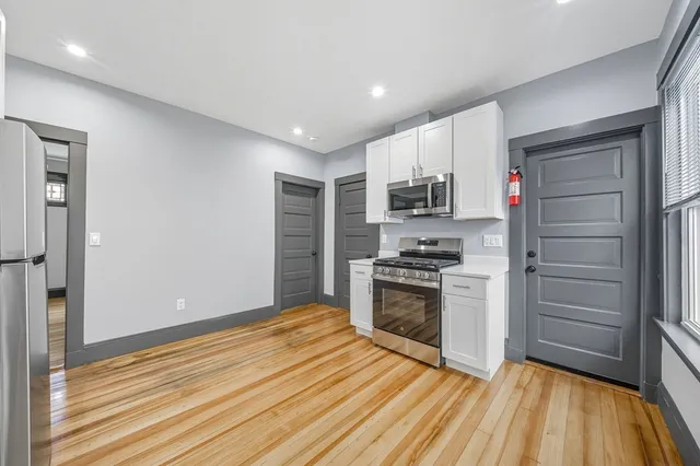 a kitchen with granite countertop a stove and a refrigerator
