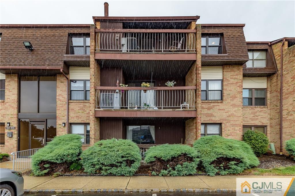 1607 Raspberry Court, Unit 1607 Edison, NJ 08817 - Photo 1 of 14 a front view of a house with balcony and garage