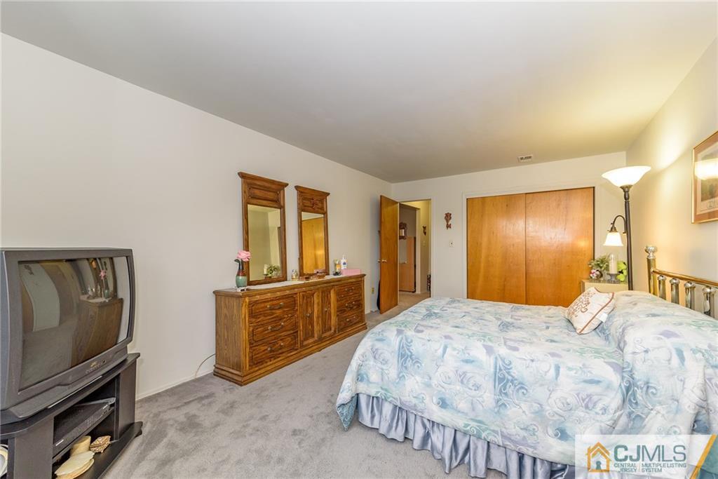 1607 Raspberry Court, Unit 1607 Edison, NJ 08817 - Photo 13 of 14 a bedroom with a bed and dresser