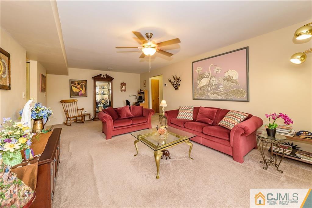1607 Raspberry Court, Unit 1607 Edison, NJ 08817 - Photo 3 of 14 a living room with furniture and a chandelier