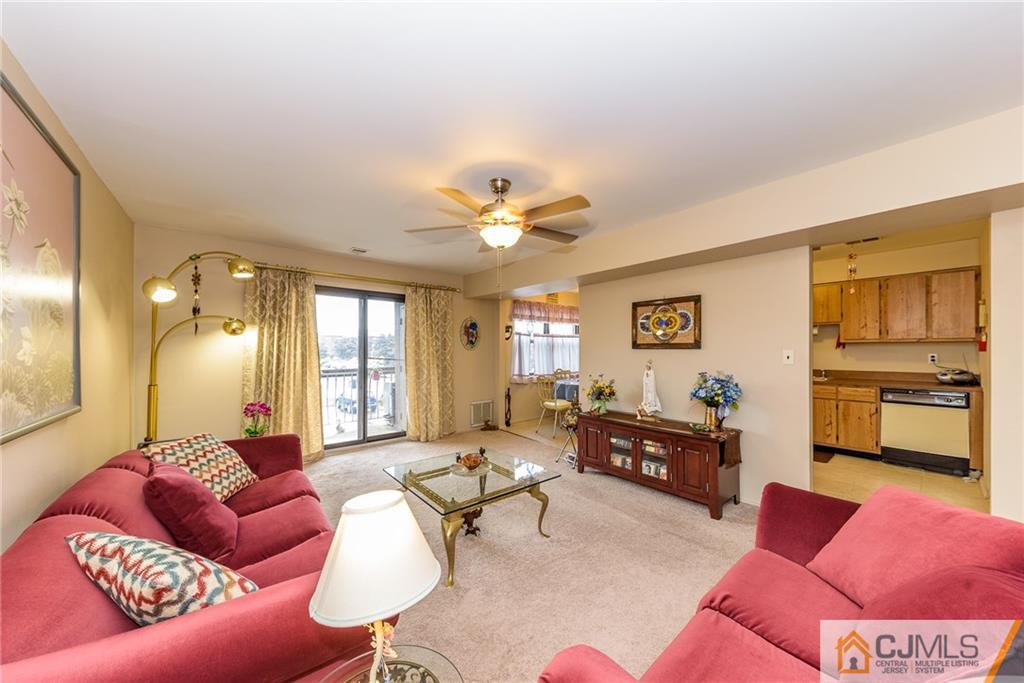 1607 Raspberry Court, Unit 1607 Edison, NJ 08817 - Photo 4 of 14 a living room with furniture and a large window