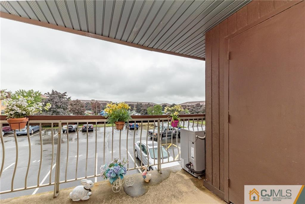 1607 Raspberry Court, Unit 1607 Edison, NJ 08817 - Photo 10 of 14 a view of a balcony with chair and glass door