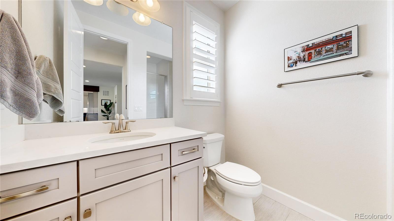 1476 Red Sun Way Highlands Ranch, CO 80126 - Photo 12 of 37 a view of bathroom with a toilet sink and mirror