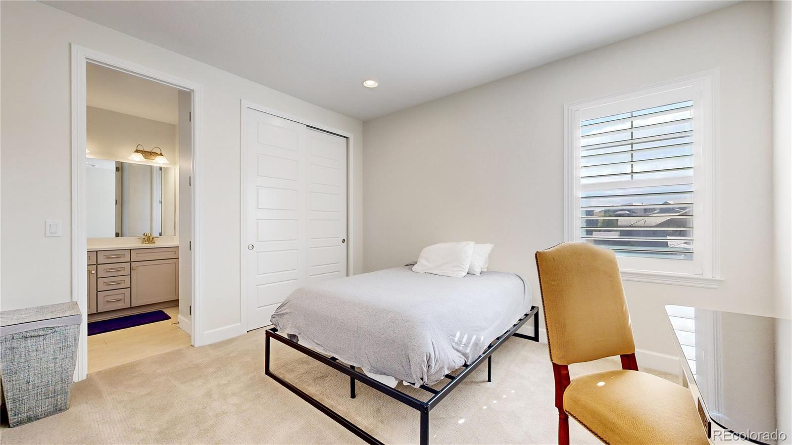 1476 Red Sun Way Highlands Ranch, CO 80126 - Photo 13 of 37 a bedroom with a bed and a chair