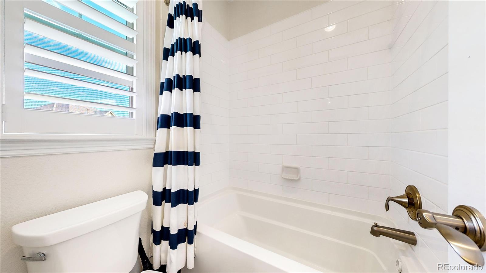 1476 Red Sun Way Highlands Ranch, CO 80126 - Photo 16 of 37 a bathroom with a bathtub and a shower