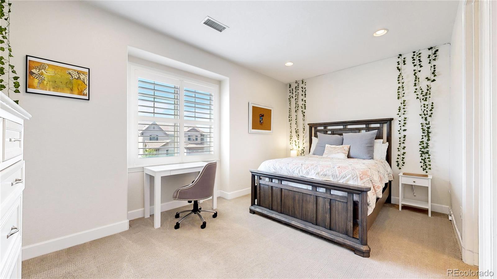 1476 Red Sun Way Highlands Ranch, CO 80126 - Photo 17 of 37 a bedroom with a bed and a table