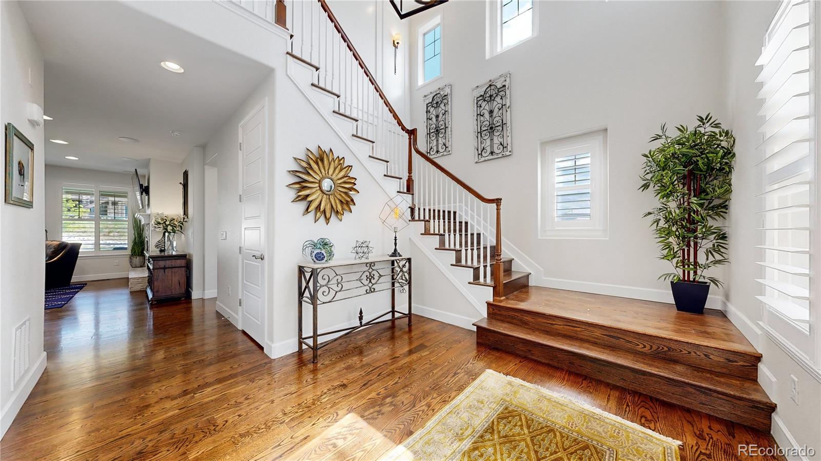 1476 Red Sun Way Highlands Ranch, CO 80126 - Photo 2 of 37 a view of entryway and hall with wooden floor