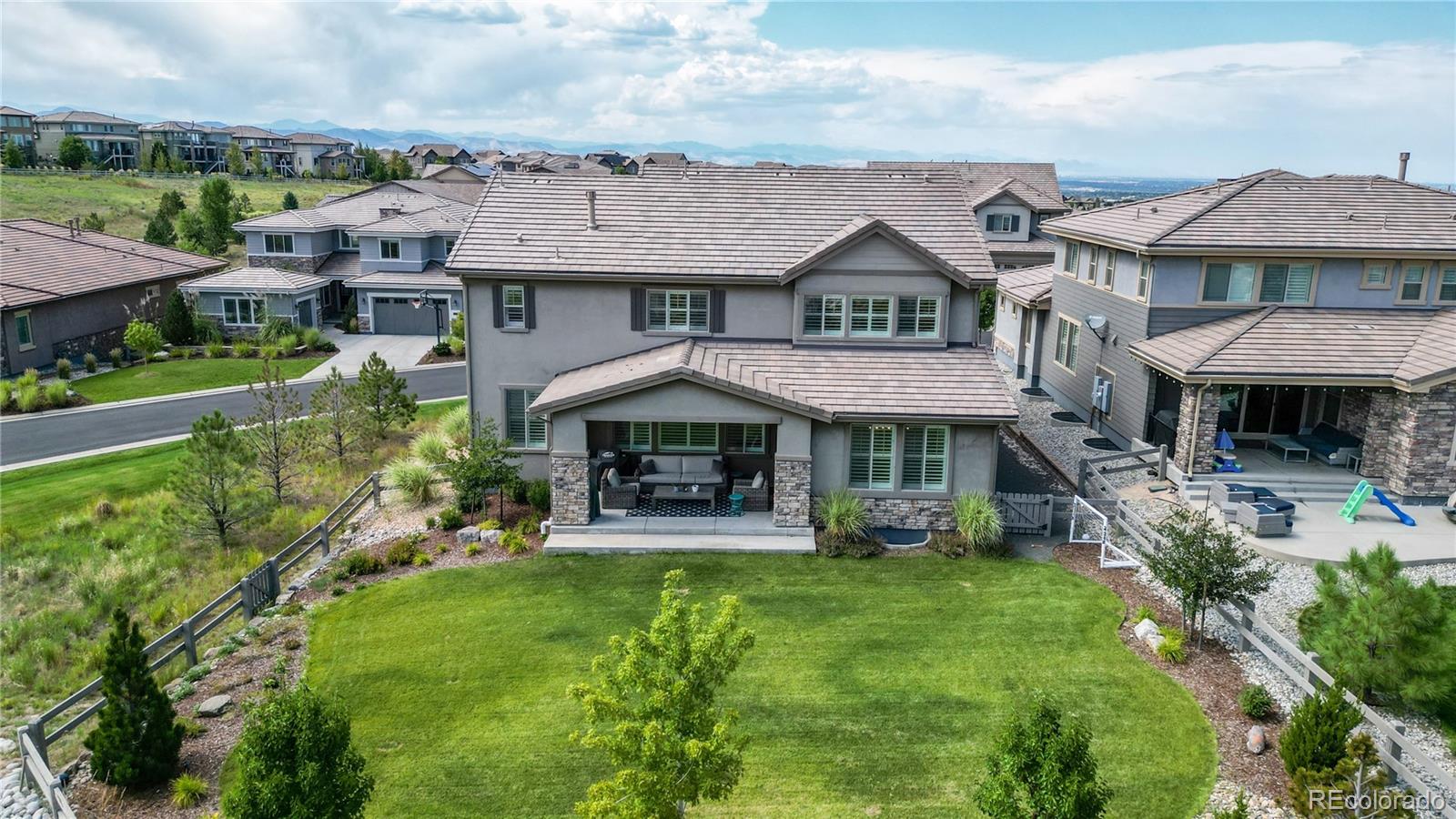1476 Red Sun Way Highlands Ranch, CO 80126 - Photo 32 of 37 a view of a house with a yard and potted plants