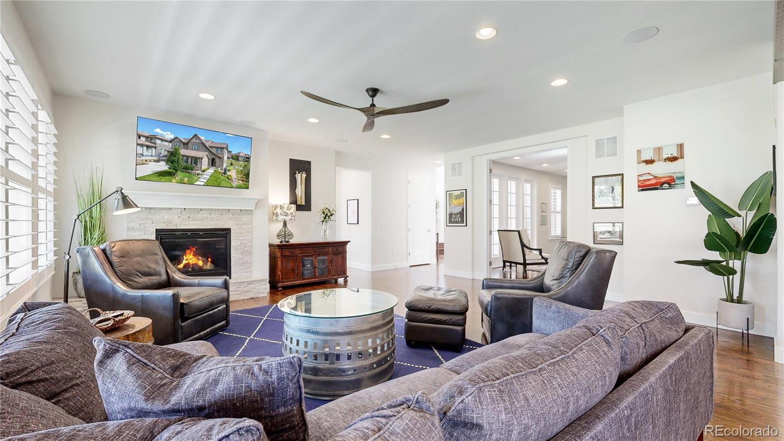 1476 Red Sun Way Highlands Ranch, CO 80126 - Photo 5 of 37 a living room with furniture a fireplace and a potted plant