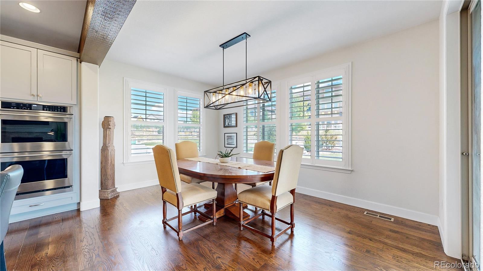 1476 Red Sun Way Highlands Ranch, CO 80126 - Photo 6 of 37 a view of a dining room with furniture window and wooden floor