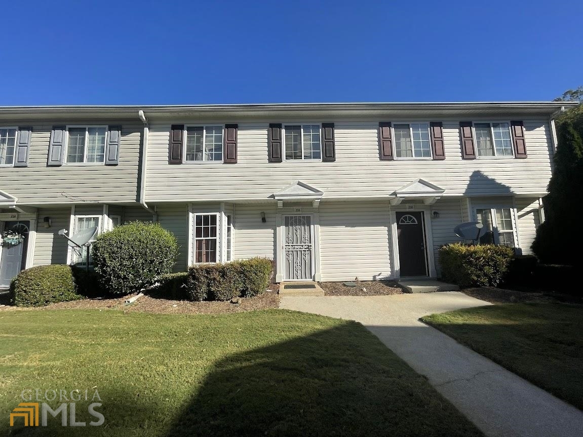 a front view of a house with a yard