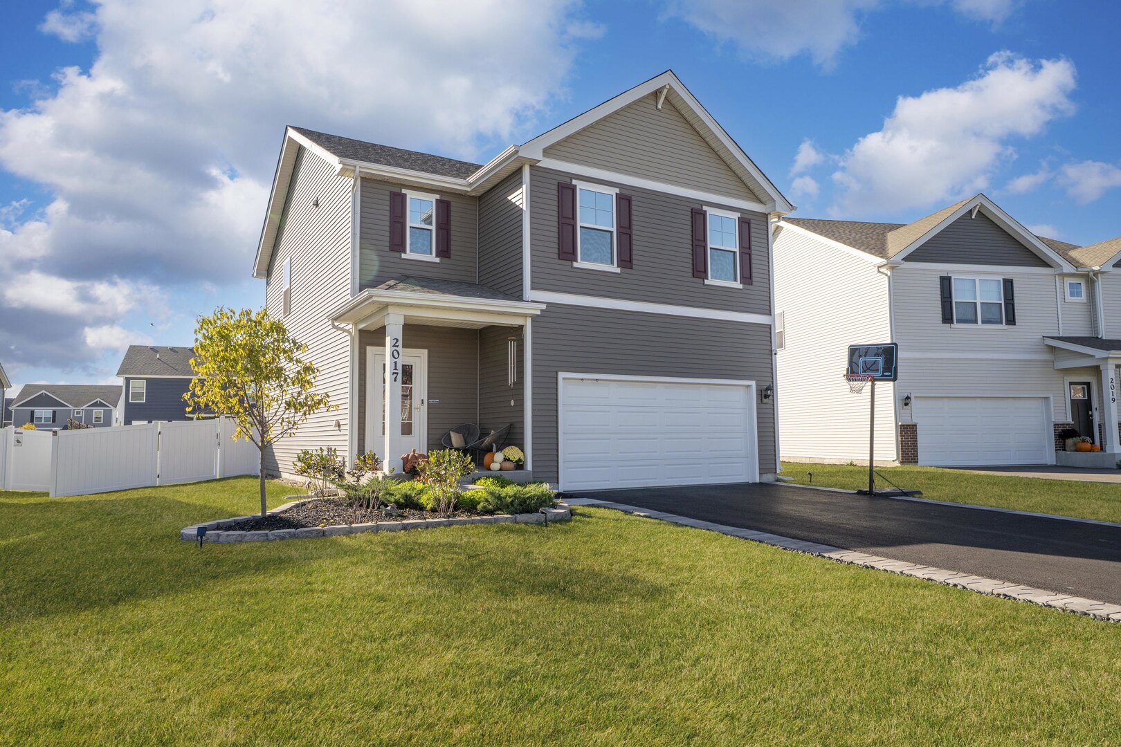 2017 Lilyana Lane Plainfield, IL 60586 - Photo 1 of 43 a front view of house with yard and trees in the background